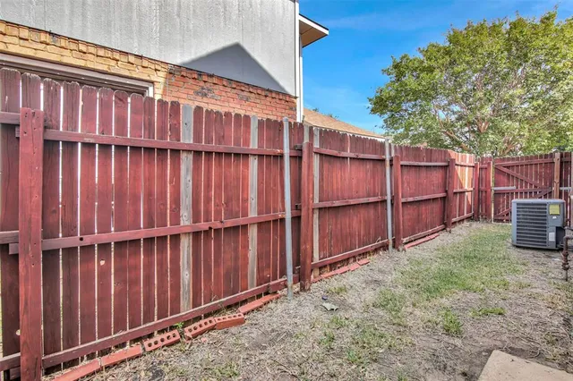a backyard of a house with wooden fence