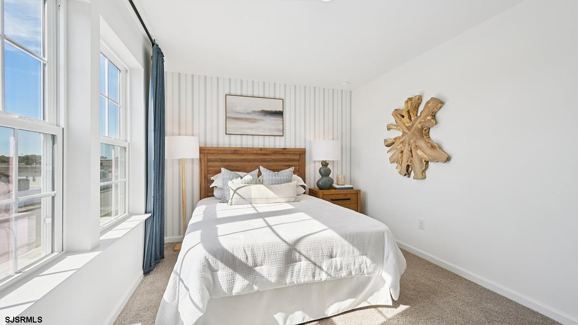 607 Scotty Boulevard, Unit 1404 Rio Grande, NJ 08242 - Photo 37 of 46 a bedroom with a bed and a painting on the wall