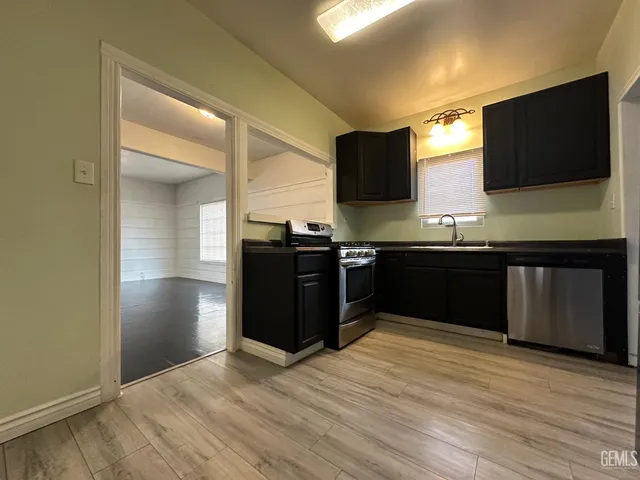 a kitchen with stainless steel appliances granite countertop a sink and a microwave