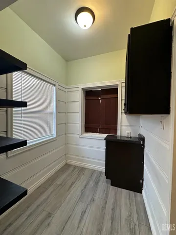 a living room with hard wood floors and a flat screen tv
