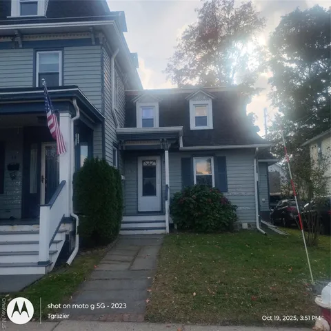 a view of a house next to a yard