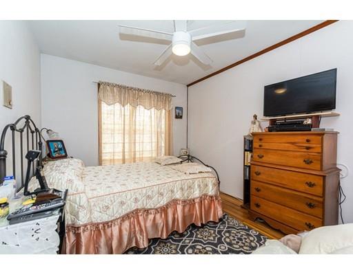 36 Howard Road Medford, MA 02155 - Photo 12 of 39 a bedroom with a bed and a flat screen tv