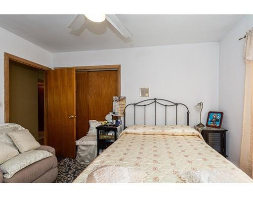 36 Howard Road Medford, MA 02155 - Photo 13 of 39 a large bedroom with a bed and wooden floor