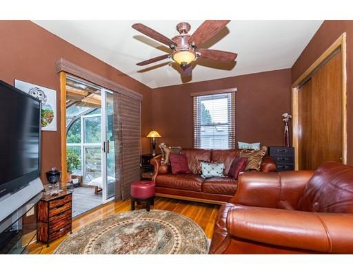 36 Howard Road Medford, MA 02155 - Photo 15 of 39 a living room with furniture a chandelier and a flat screen tv