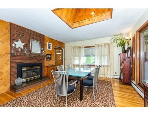 36 Howard Road Medford, MA 02155 - Photo 5 of 39 a dining room with furniture and a fireplace