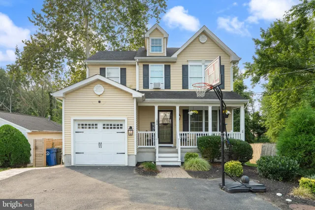 a view of a house with a yard and potted plants