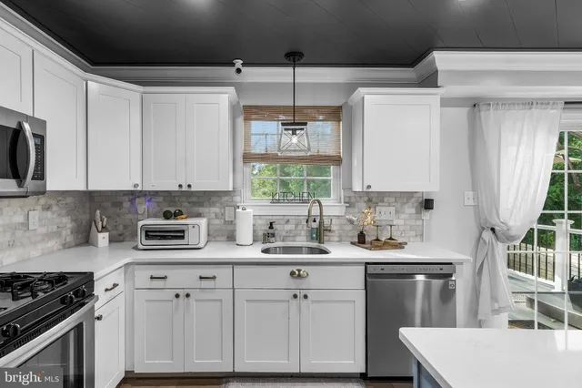 a kitchen with a sink stove and cabinets