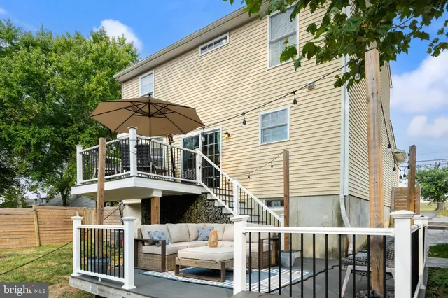 a view of a white house with a small yard and a large window