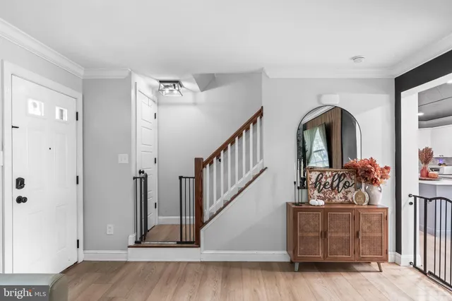 a view of entryway and hall with wooden floor