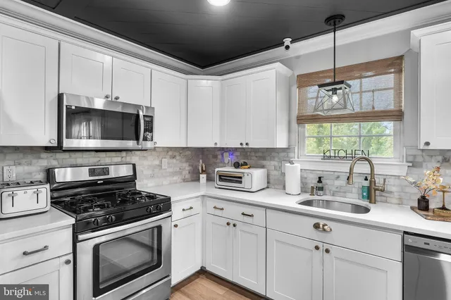 a kitchen with a sink stove and microwave