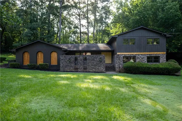 a front view of a house with a garden
