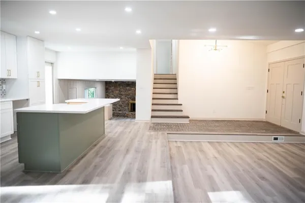a large white kitchen with a sink and dishwasher
