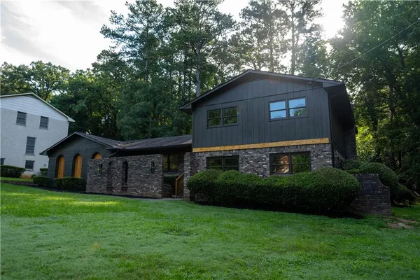 a front view of a house with a garden