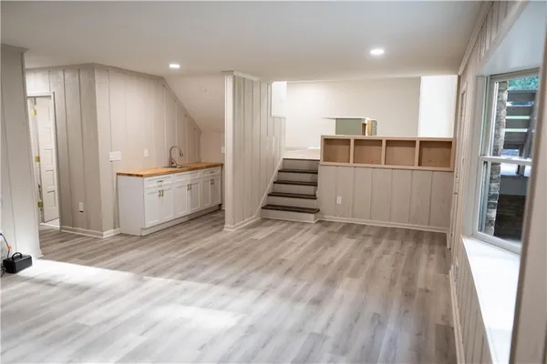 a view of a kitchen with wooden floor and electronic appliances
