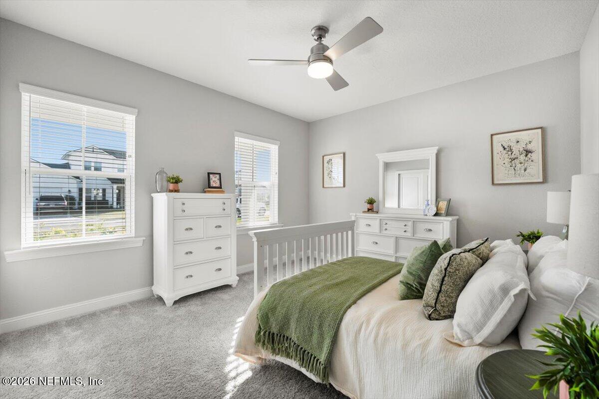 219 Morning Mist Lane St. Johns, FL 32259 - Photo 17 of 81 a bedroom with a bed a dresser and a window