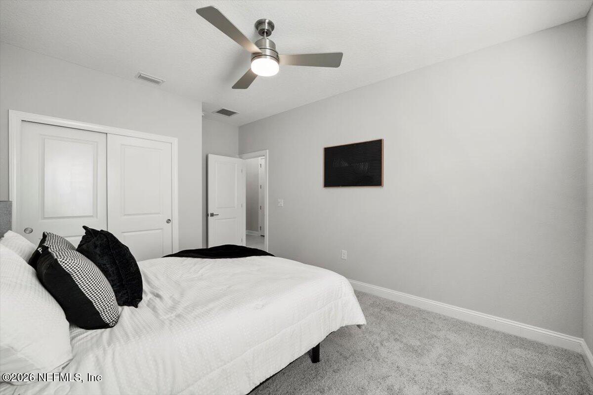 219 Morning Mist Lane St. Johns, FL 32259 - Photo 20 of 81 a bedroom with a bed and a flat screen tv