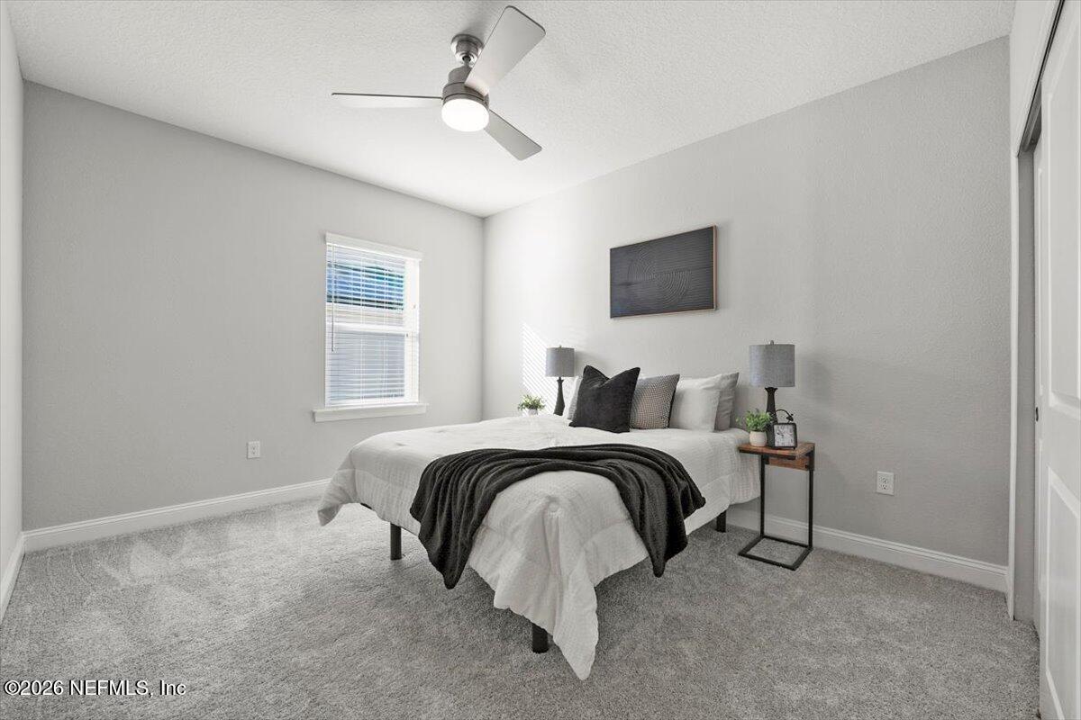 219 Morning Mist Lane St. Johns, FL 32259 - Photo 21 of 81 a bedroom with bed and a flat screen tv
