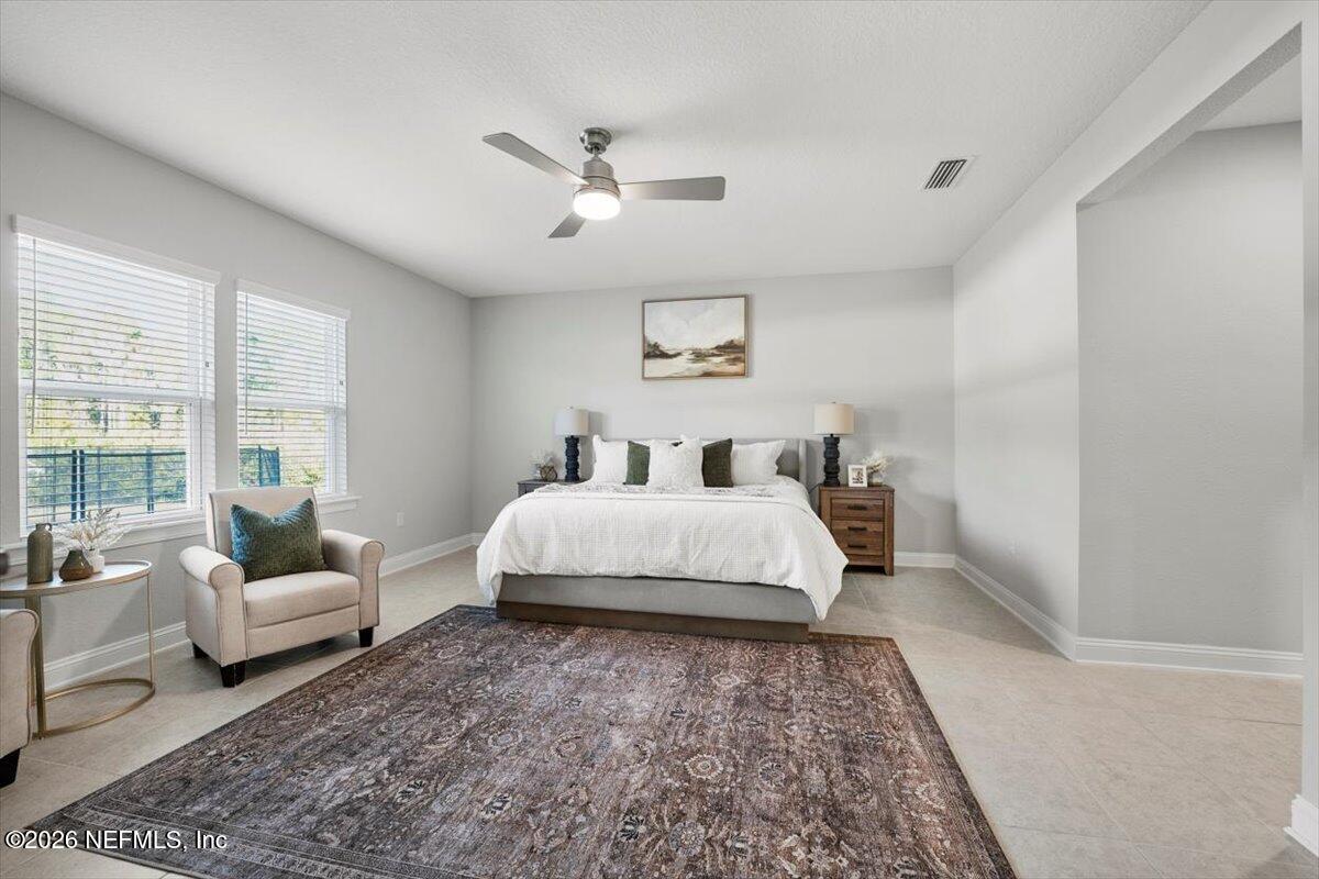 219 Morning Mist Lane St. Johns, FL 32259 - Photo 25 of 81 a bedroom with a bed and a couch