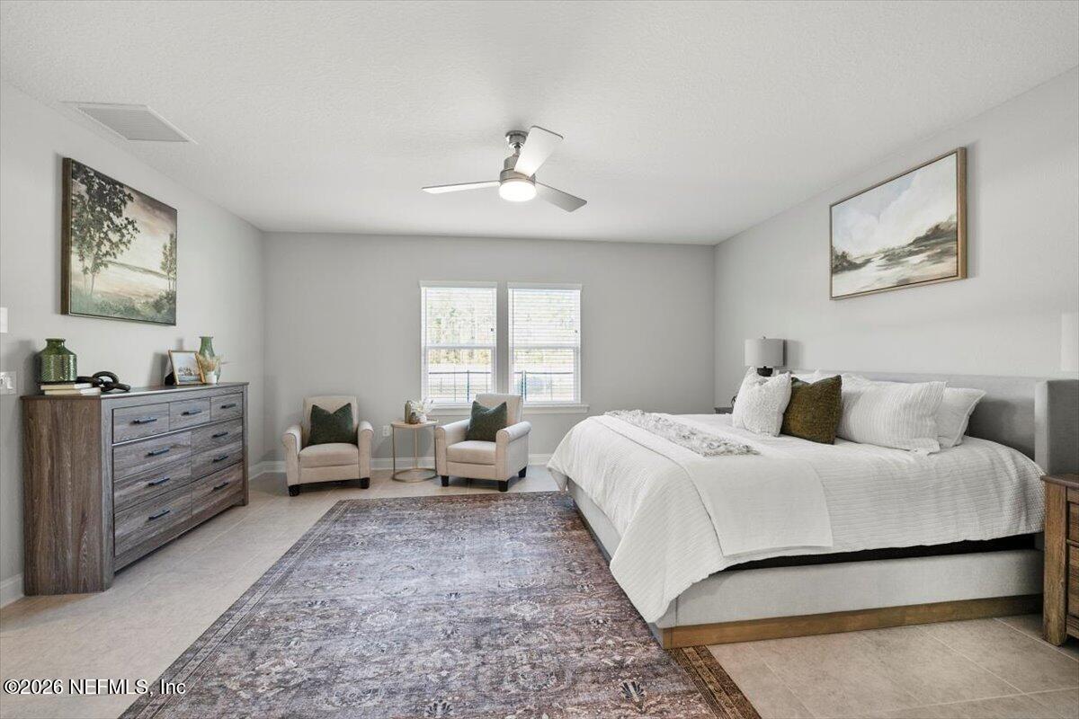 219 Morning Mist Lane St. Johns, FL 32259 - Photo 27 of 81 a bedroom with a bed and wooden floor