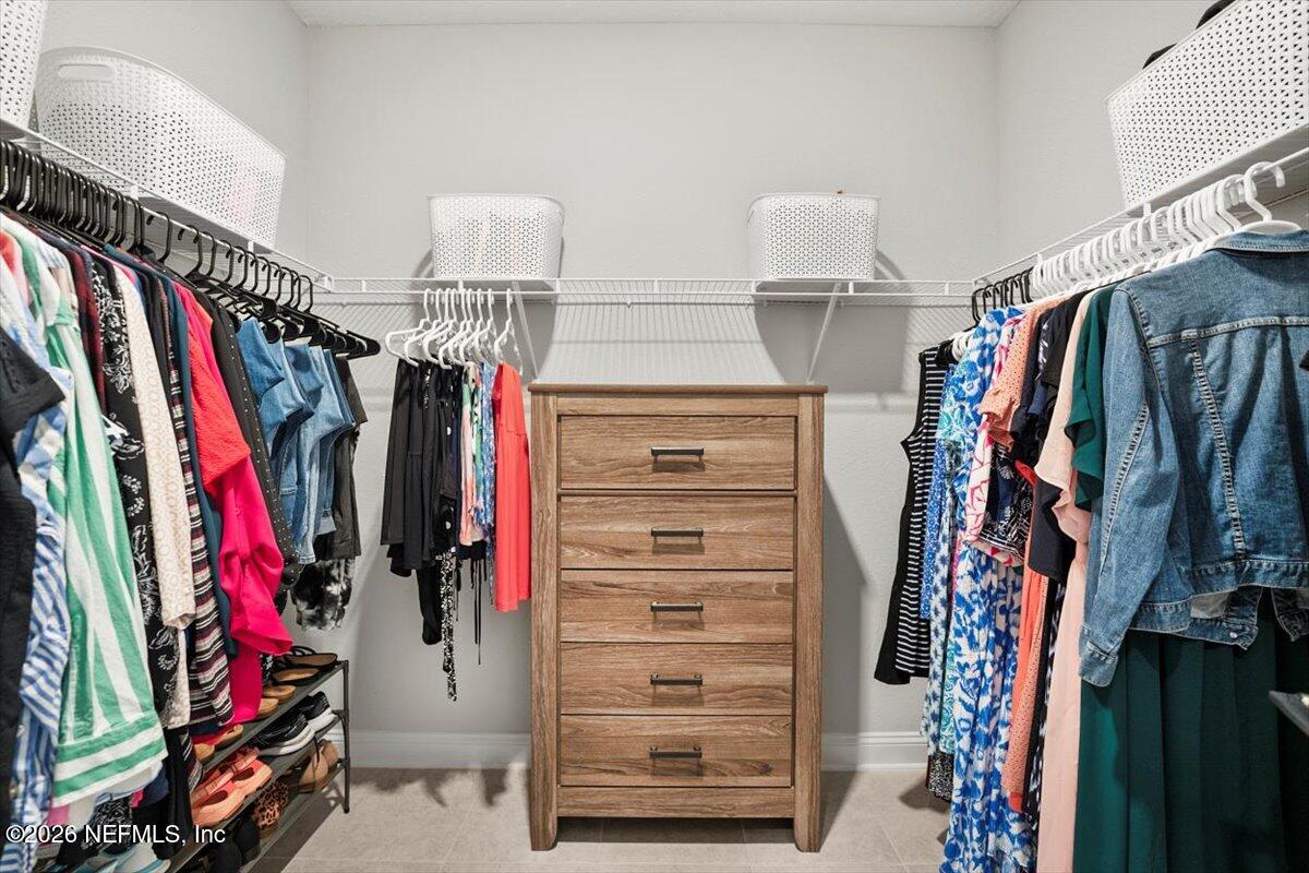 219 Morning Mist Lane St. Johns, FL 32259 - Photo 31 of 81 a view of walk in closet with clothes and shoes