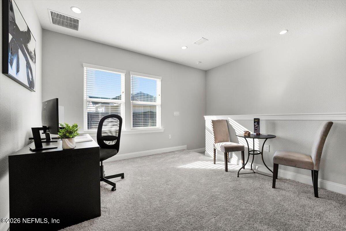 219 Morning Mist Lane St. Johns, FL 32259 - Photo 33 of 81 a living room with furniture a fireplace and a window