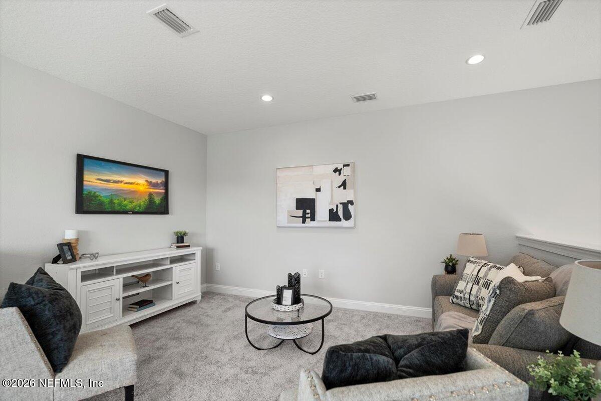 219 Morning Mist Lane St. Johns, FL 32259 - Photo 34 of 81 a living room with furniture and a flat screen tv