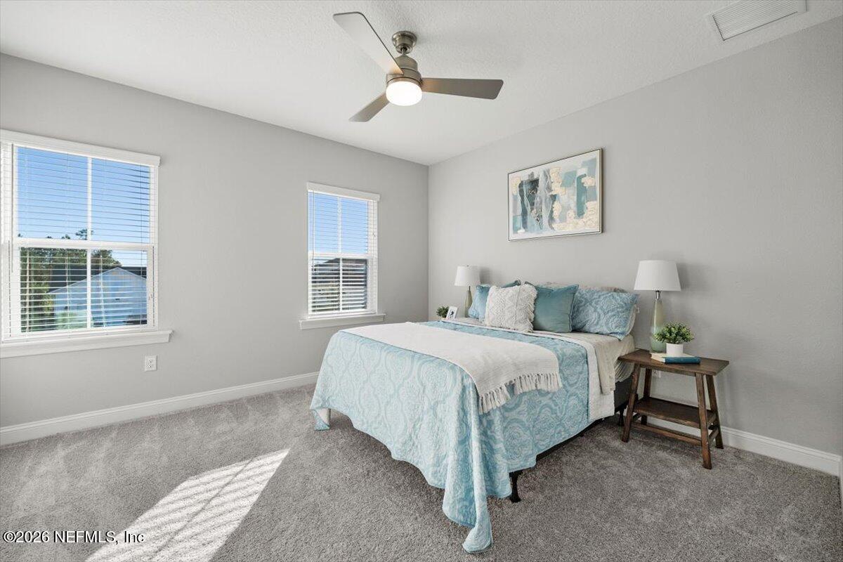 219 Morning Mist Lane St. Johns, FL 32259 - Photo 37 of 81 a spacious bedroom with a bed and a window