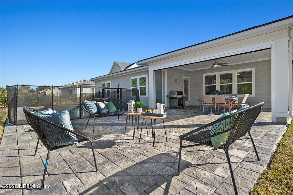 219 Morning Mist Lane St. Johns, FL 32259 - Photo 42 of 81 a view of a patio with table and chairs with wooden floor and fence