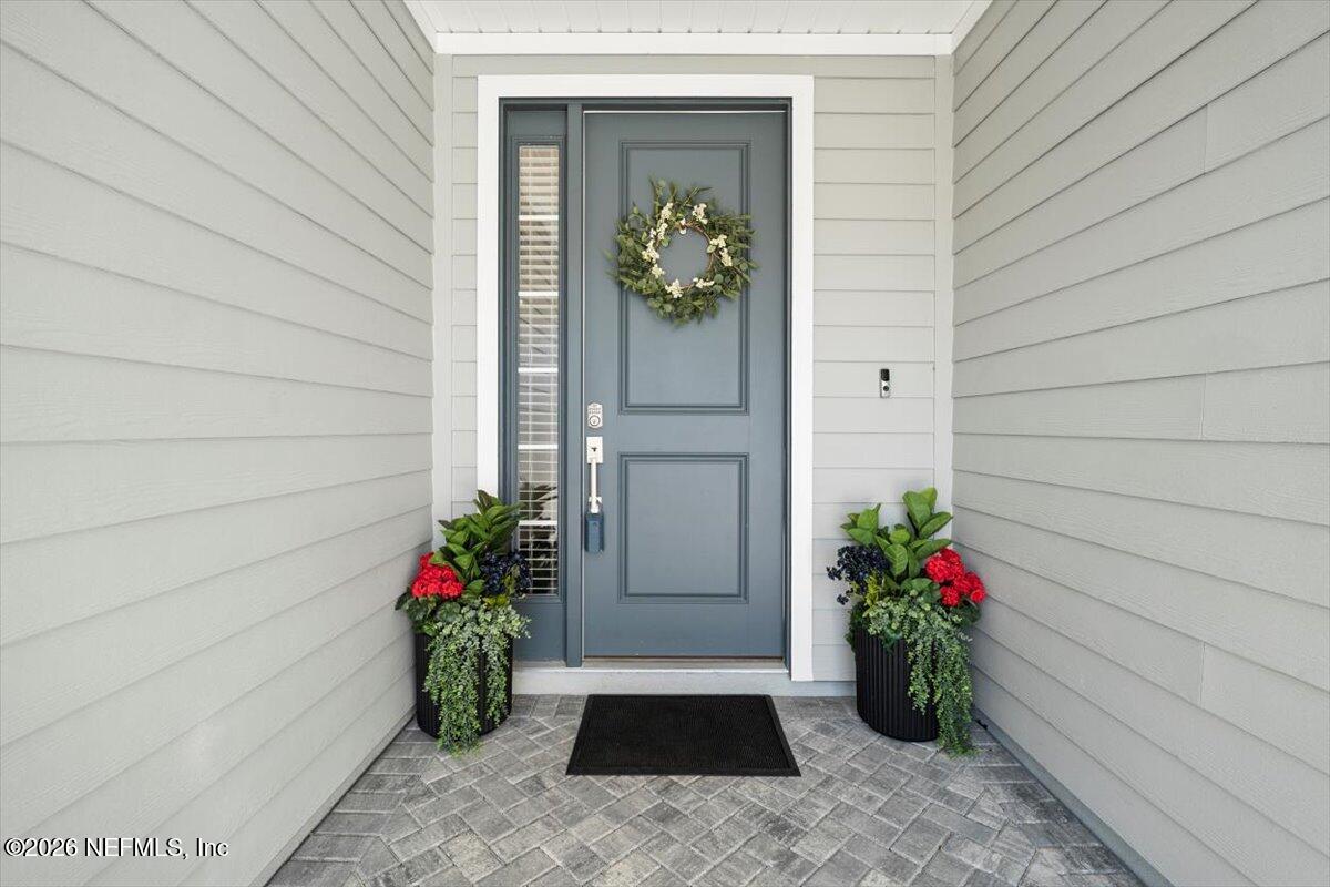 219 Morning Mist Lane St. Johns, FL 32259 - Photo 5 of 81 a vase with flowers sitting on a floor in front of a door