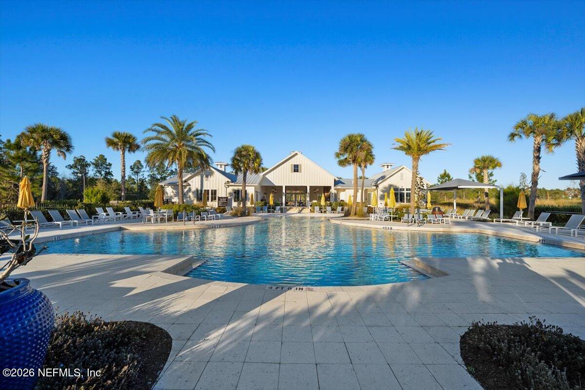 219 Morning Mist Lane St. Johns, FL 32259 - Photo 58 of 81 a view of a swimming pool with an outdoor space and seating area
