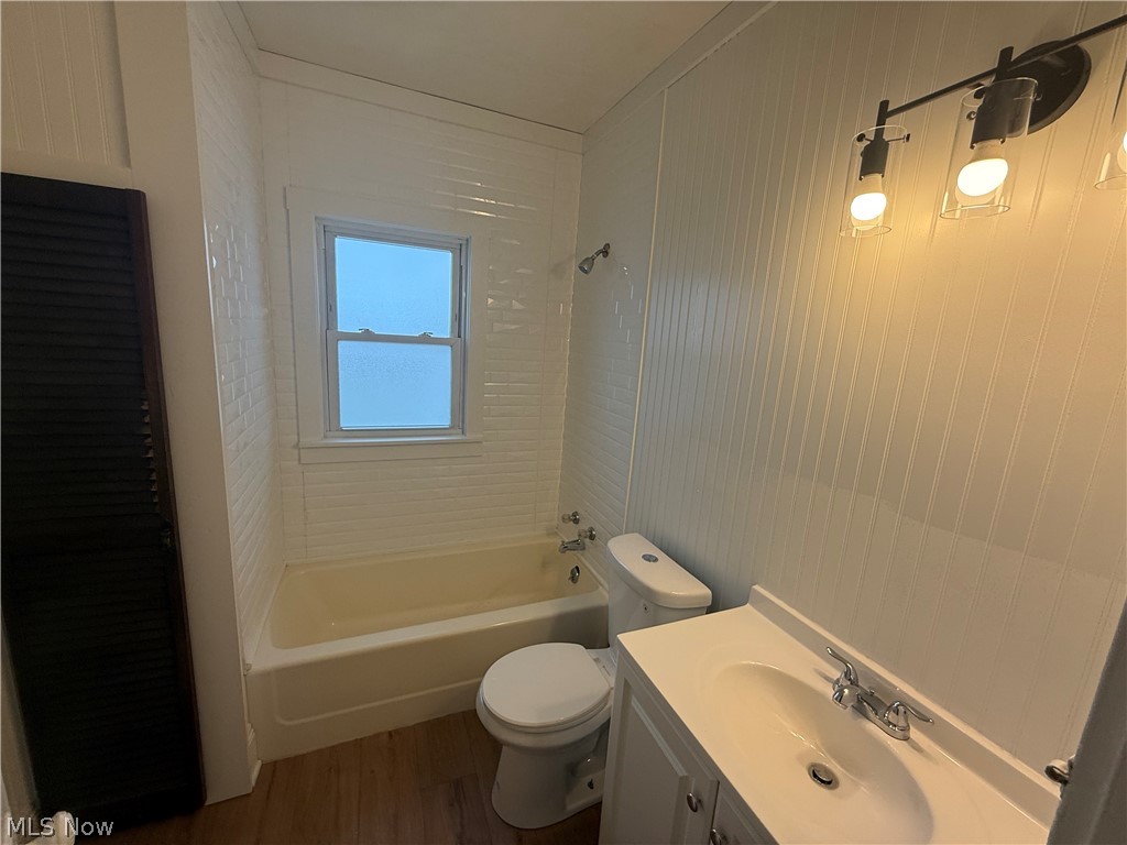 3612 Riverside Avenue Cleveland, OH 44109 - Photo 17 of 22 Bathroom featuring a white vanity with integrated sink, chrome faucet, and contemporary four-light fixture