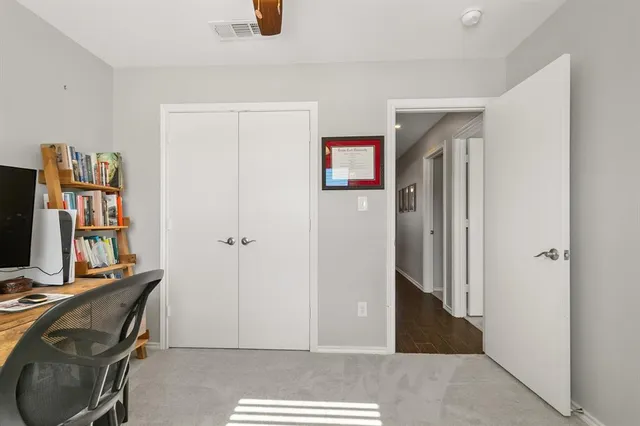 a view of a workspace with furniture and closet