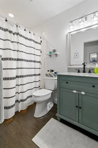 a bathroom with a toilet sink and mirror