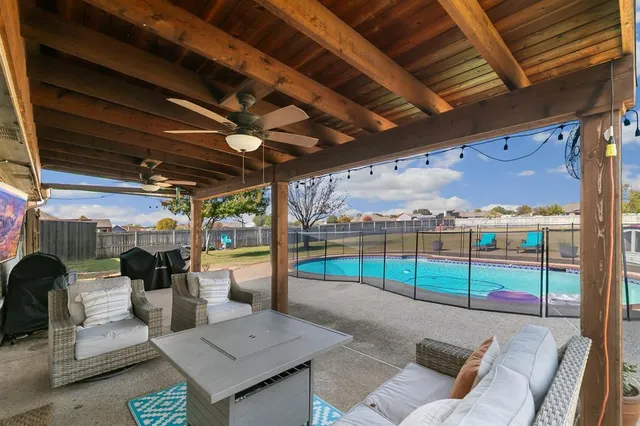 a view of a patio with a table and chairs
