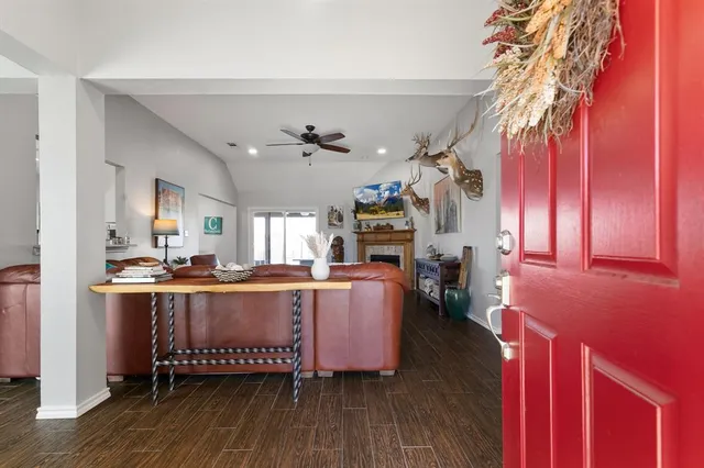 a living room with fireplace furniture and a chandelier