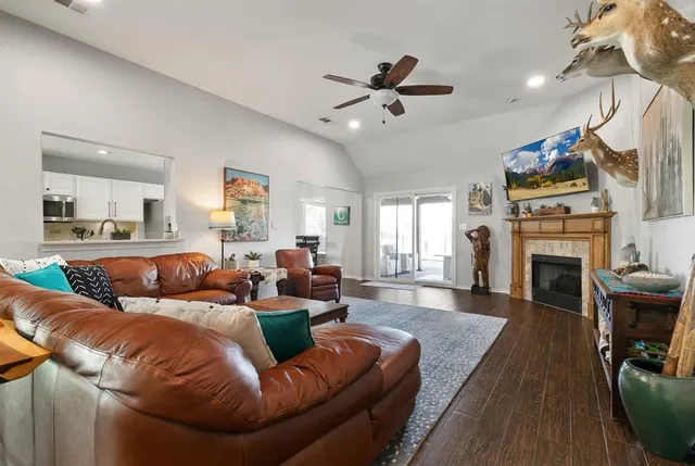 a living room with furniture a fireplace and a flat screen tv
