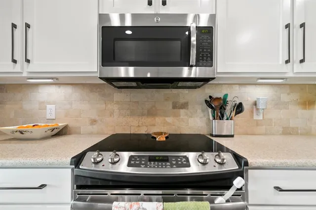 a kitchen with a stove and a microwave