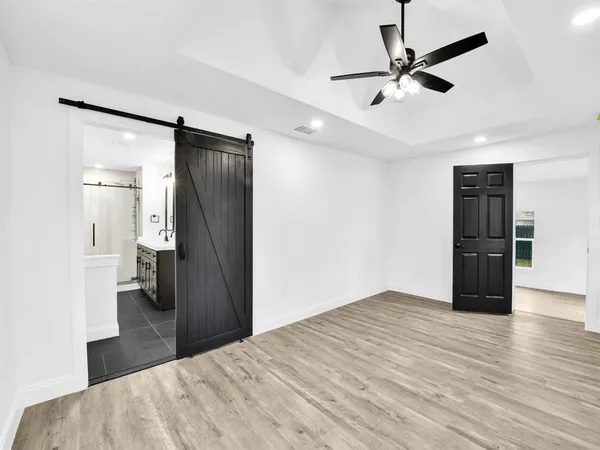 a view of empty room with wooden floor
