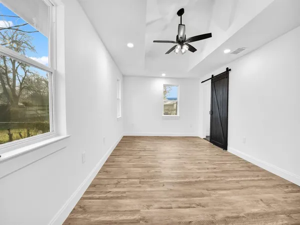 a view of a livingroom with a ceiling fan and window