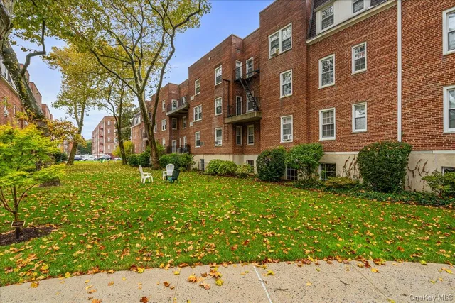 a view of a brick building next to a yard