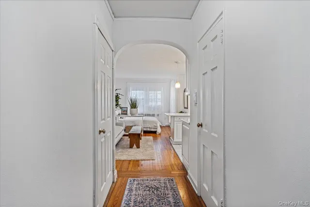 a hallway with a dining table and chairs