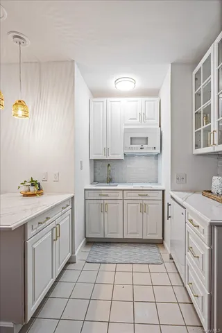a kitchen with a sink window and cabinets