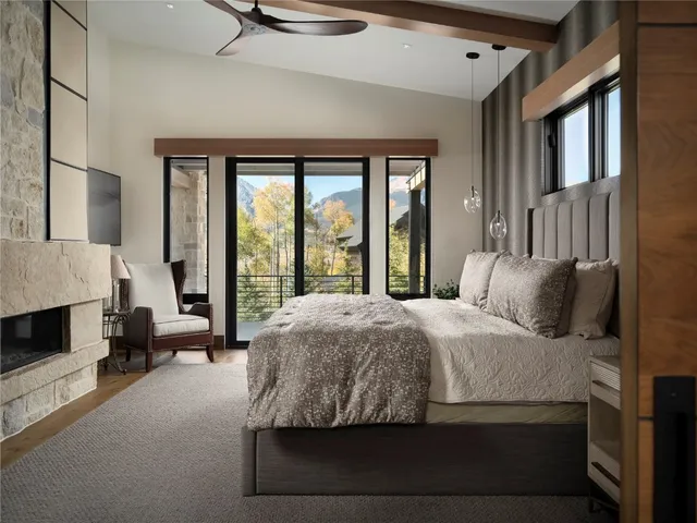 a bedroom with a bed couch and a large window