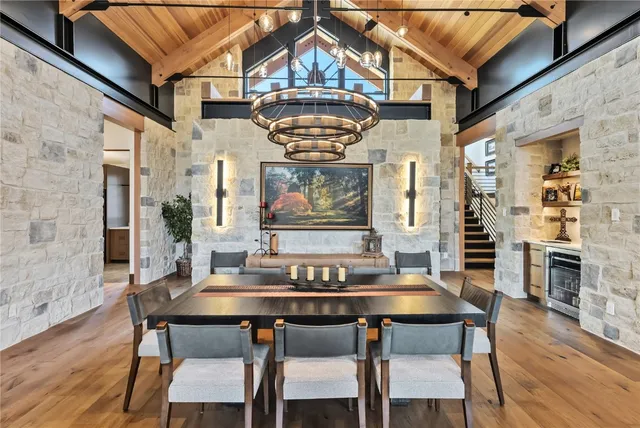 a view of a dining room with furniture wooden floor and a chandelier