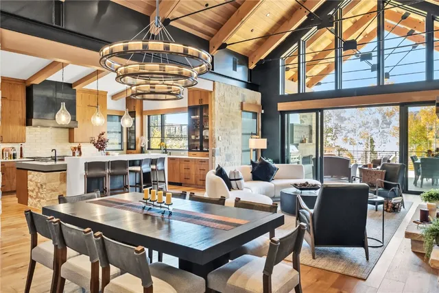 a view of a dining room with furniture large windows and wooden floor