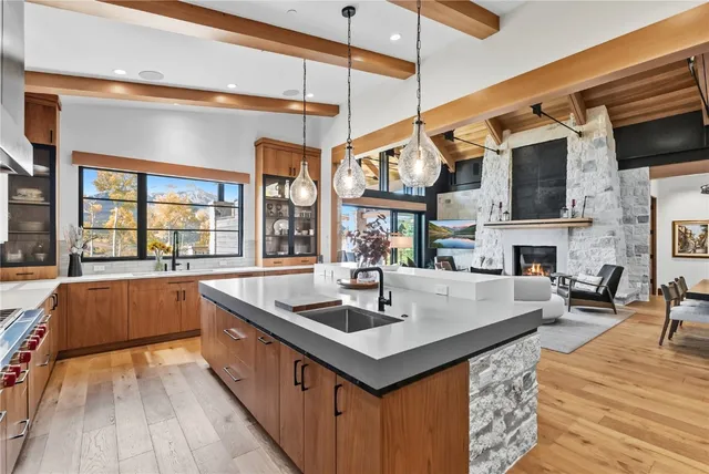 a kitchen with stainless steel appliances granite countertop a sink and a wooden floors