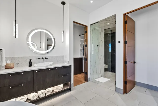 a spacious bathroom with a double vanity sink and a mirror