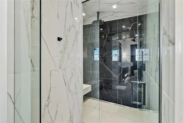a bathroom with a glass shower door