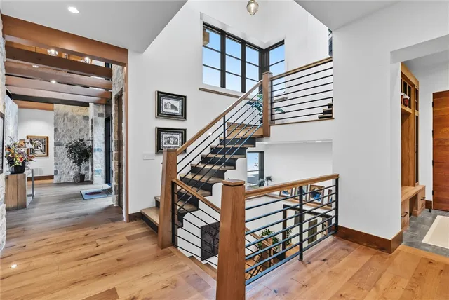 a view of entryway and hall with wooden floor