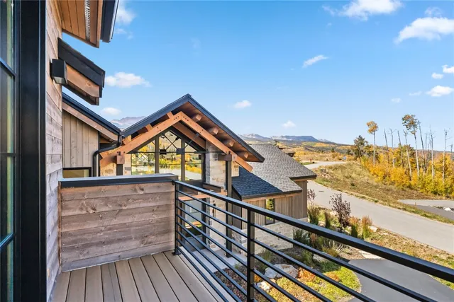 a view of a balcony with wooden floor and fence